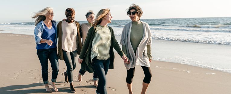 senior-women-strolling-on-beach